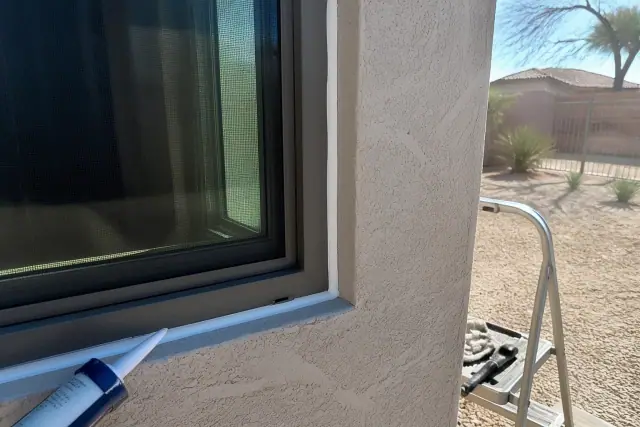 Caulk sealant applied to a window frame on a stucco wall at a jobsite in Phoenix, AZ.