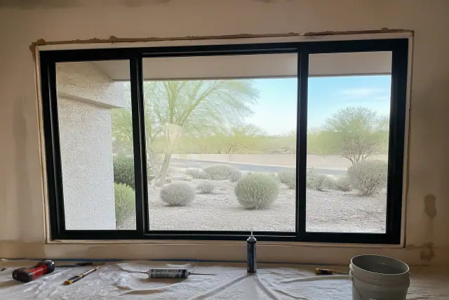 Window frame installation during a repair project on a stucco wall in Phoenix, AZ.