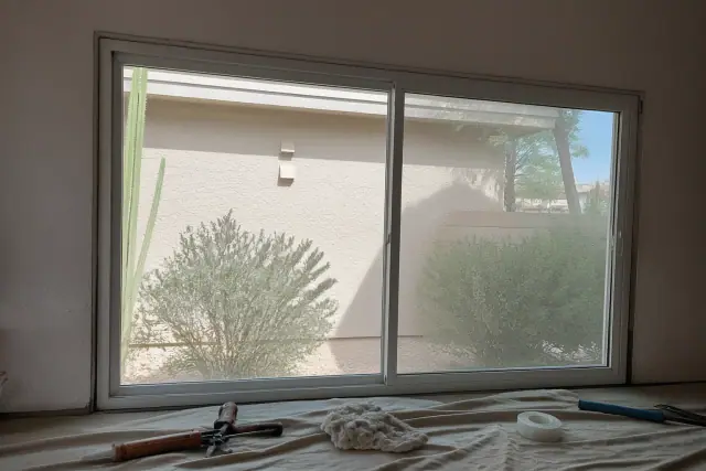Sliding window frame installation in progress at a residential job site in Mesa, AZ.