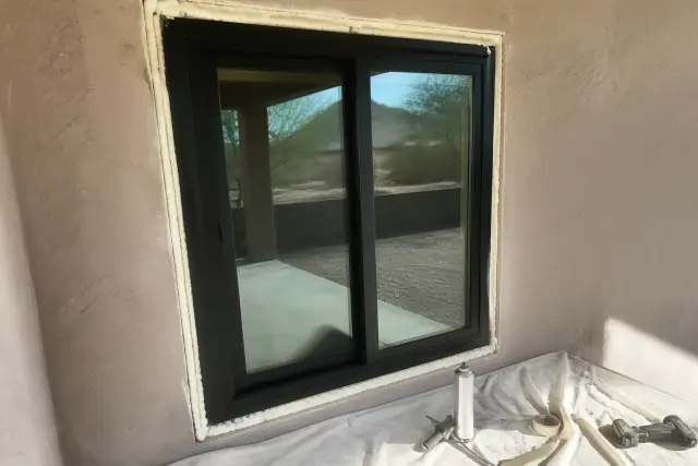 A sliding window installed in a stucco wall on a residential job site in Phoenix, AZ.