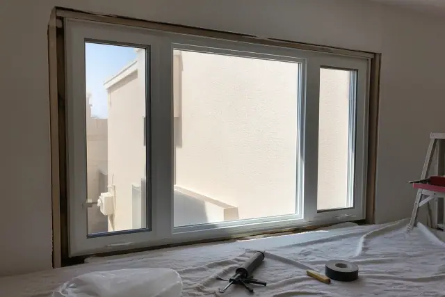 Triple-pane, low-E vinyl window frame installed in a stucco wall at a jobsite in Phoenix, AZ.