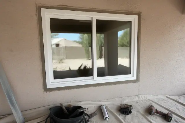 Vinyl window installation on a stucco wall at a jobsite in Phoenix, AZ.