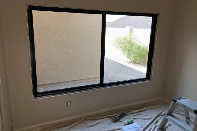 Window frame installation with tools on a drop cloth in Phoenix, AZ.