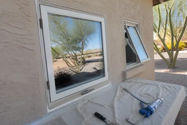 Completed glass window repair and hardware installation on a stucco home in Phoenix, AZ.