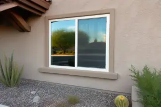 Sealed window frame perimeter on a stucco home in Phoenix, AZ, with a xeriscaped front yard.