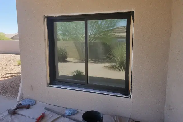 Window frame installation in progress on a stucco wall at a jobsite in Phoenix, AZ.