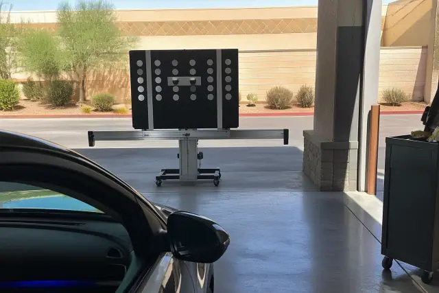 ADAS calibration target set up in front of a vehicle at an auto glass repair shop in Phoenix, AZ.