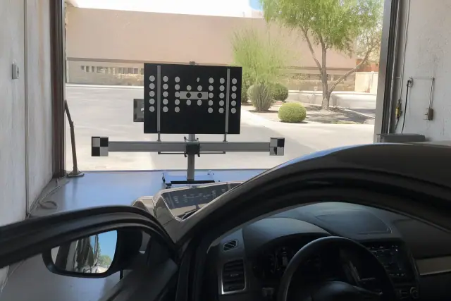 ADAS calibration target stand set up for a vehicle in a Phoenix, AZ service bay.