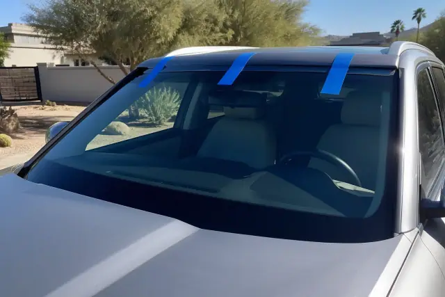 Newly installed windshield with retention tape on a vehicle in Phoenix, AZ.