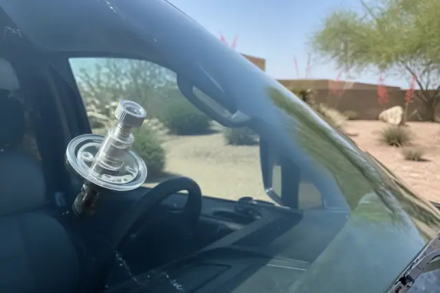 Resin injector tool repairing a star break on a car windshield in Goodyear, AZ.
