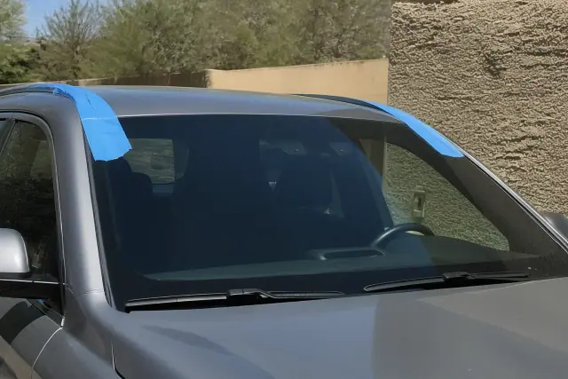 Newly installed car windshield with retention tape on a vehicle in Goodyear, AZ.
