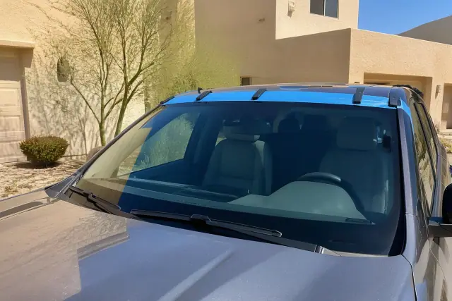 Newly installed vehicle windshield with retention tape at a jobsite in Phoenix, AZ.