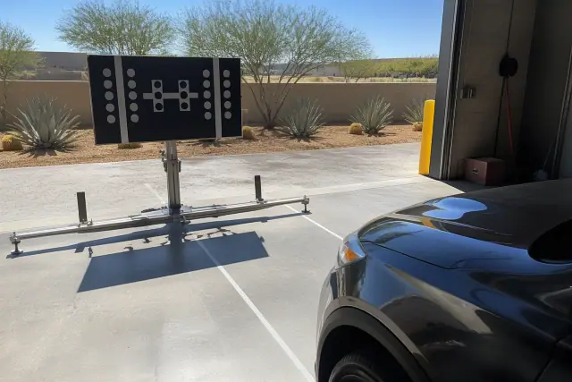 ADAS camera calibration target stand set up in a service bay at a job site in Phoenix, AZ.