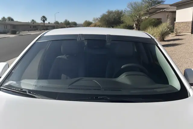 New windshield with retention tape installed on a vehicle at a job site in Phoenix, AZ.