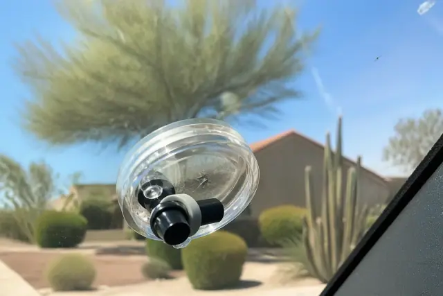 Resin injector tool repairing a star break on a vehicle windshield in Phoenix, AZ.