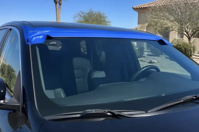 Newly installed car windshield with retention tape on a vehicle in Phoenix, AZ.