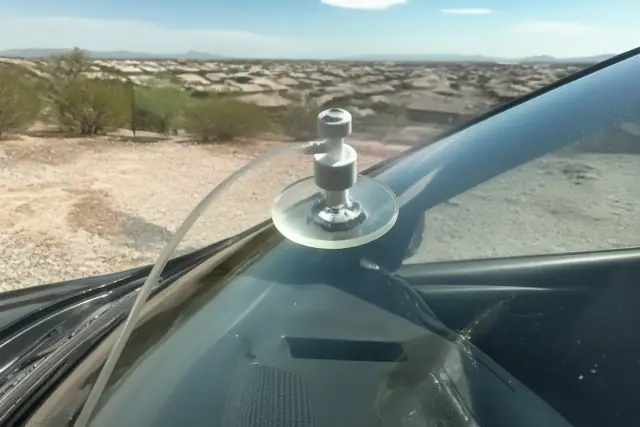 Resin injector tool repairing a star break on a car windshield in Phoenix, AZ.