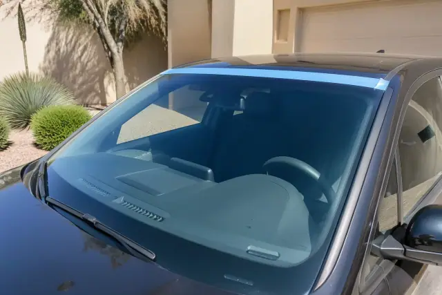 Newly installed car windshield with retention tape on a vehicle in Glendale, AZ.
