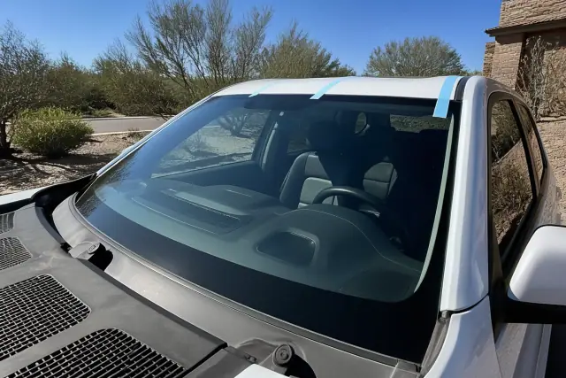 New windshield with retention tape installed on a vehicle at a jobsite in Phoenix, AZ.