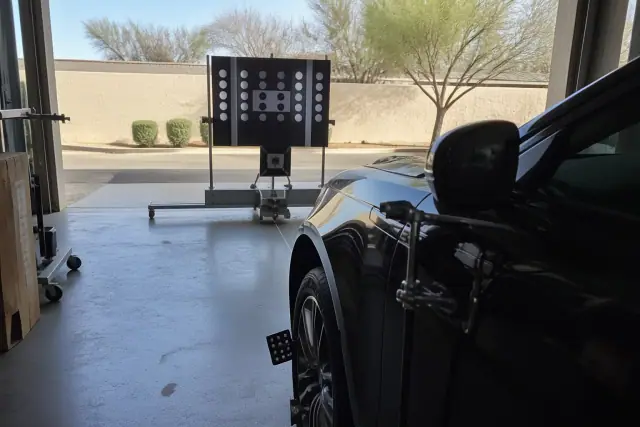 Radar and lidar ADAS calibration equipment set up in front of a vehicle at a service bay in Phoenix, AZ.