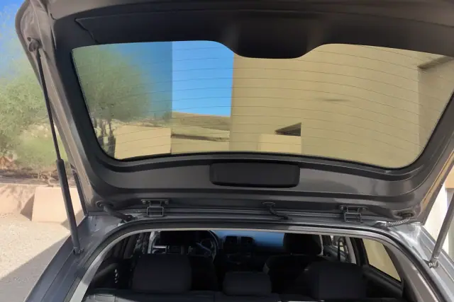 Newly installed rear car window with fresh adhesive and clean weather stripping on a hatchback in Goodyear, AZ.