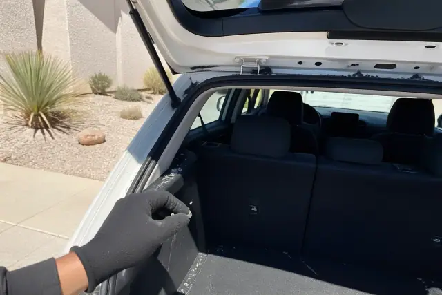 New rear windshield glass installed with retention tape on a hatchback vehicle in Peoria, AZ.