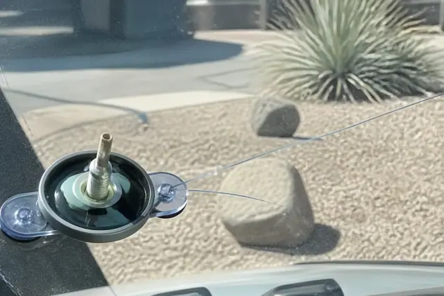 Resin injector tool on a vehicle windshield star break showing chip damage in Phoenix, AZ.
