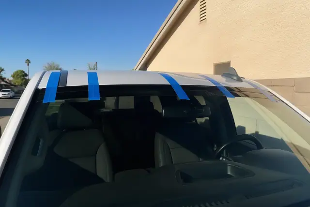 Retention tape applied to the top of a newly installed windshield on a vehicle in Phoenix, AZ.