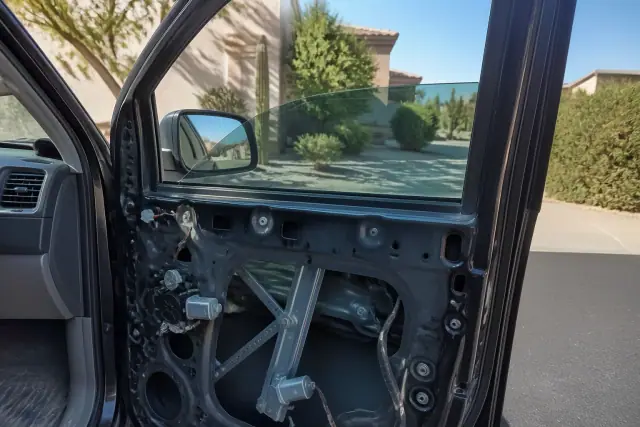 Side window glass replacement on a car with the interior panel removed in Phoenix, AZ.