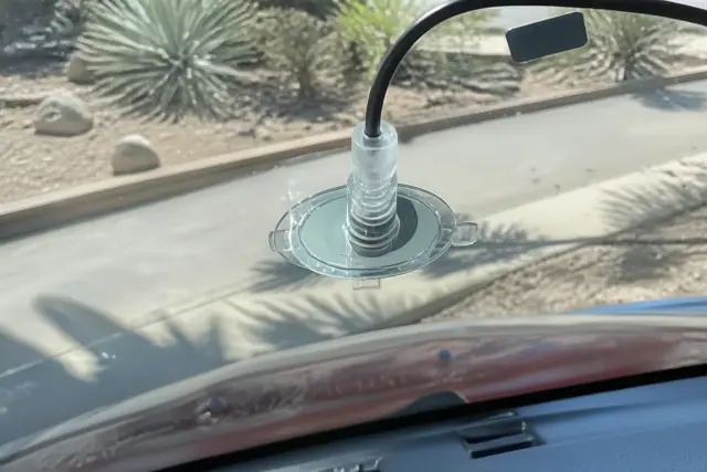 Resin injector tool repairing a star chip on a vehicle windshield at a job site in Phoenix, AZ.
