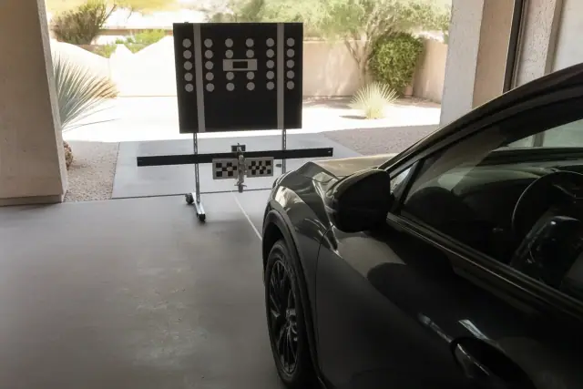 Static ADAS calibration target set up in front of a vehicle at a service bay in Phoenix, AZ.