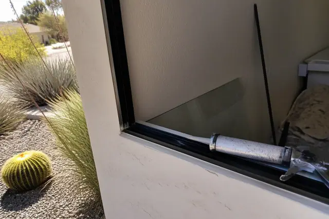 Technician preparing a vehicle door window channel for glass installation in Phoenix, AZ.