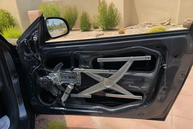 Car door with the interior panel removed to show the window regulator mechanism in Paradise Valley, AZ.