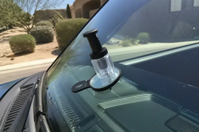 Resin injector tool repairing a star break on a vehicle windshield in Phoenix, AZ.