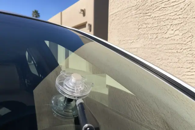 Resin injector tool repairing a star chip on a car windshield in Phoenix, AZ.