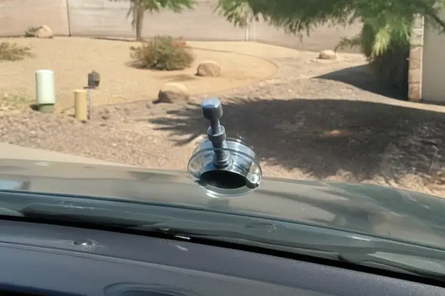 Resin injector tool repairing a star break chip on a car windshield in Phoenix, AZ.