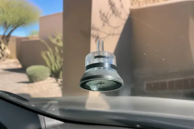 A resin injector tool repairing a star break on a car windshield at a job site in Scottsdale, AZ.