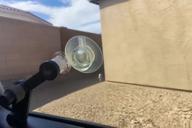 Resin injector tool repairing a star break on a vehicle windshield at a jobsite in Mesa, AZ.