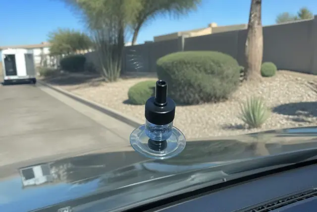 Windshield resin injector tool repairing a chip on a car windshield at a job site in Goodyear, AZ.