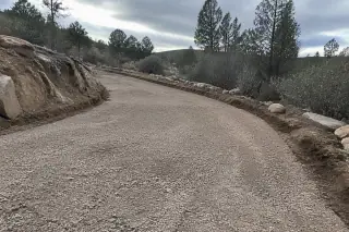 Exposed aggregate base layer prepared for paving in a desert landscape in Prescott, AZ.