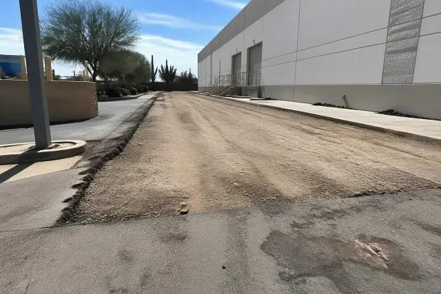 Freshly cleared asphalt sub-base at a warehouse loading dock in Scottsdale, AZ.