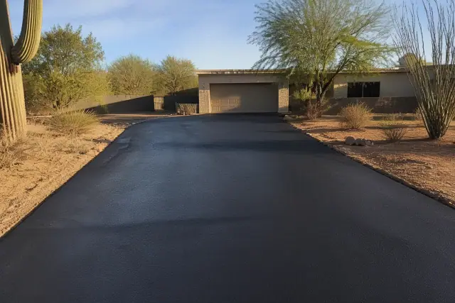 Freshly sealcoated black asphalt driveway at a desert property in Tempe, AZ.