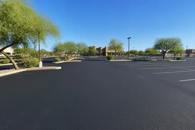 Freshly applied black asphalt sealcoating on a commercial parking lot in Scottsdale, AZ.