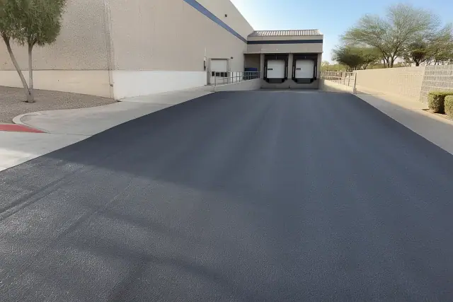 Newly paved asphalt surface at a warehouse loading dock in Scottsdale, AZ.