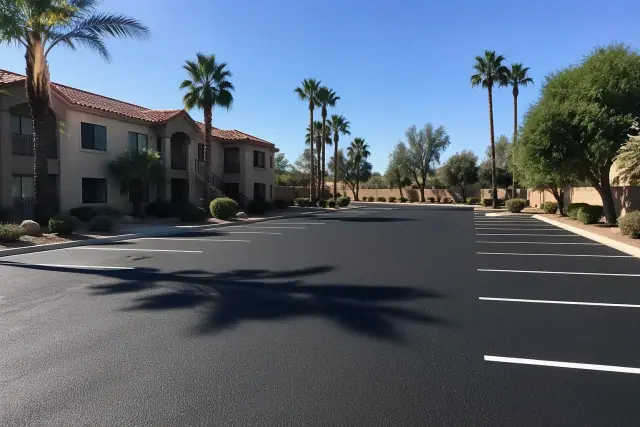 Freshly paved asphalt parking lot with white lines at an apartment complex in Scottsdale, AZ.