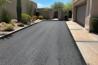 Milled asphalt texture and clean pavement edges at a residential garage in Scottsdale, AZ.