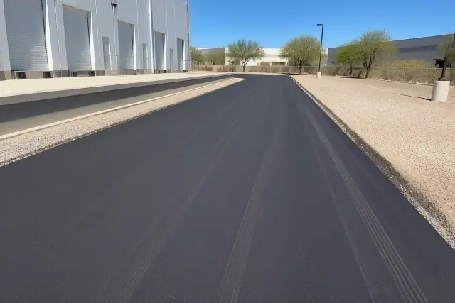 Freshly paved asphalt loading drive at a warehouse in Scottsdale, AZ.
