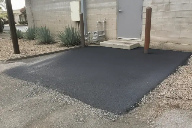 Newly repaired asphalt patch at a commercial building rear entrance in Phoenix, AZ.