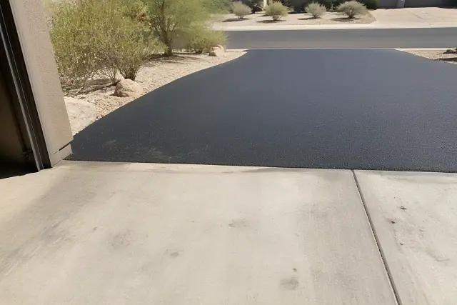 New asphalt driveway transition at a residential garage in Scottsdale, AZ.
