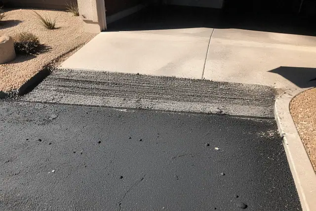 Asphalt transition between a residential garage slab and a new driveway in Mesa, AZ.
